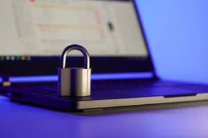 locked-metal-padlock-on-a-laptop-keyboard-over-blu-2022-10-18-16-56-16-utc